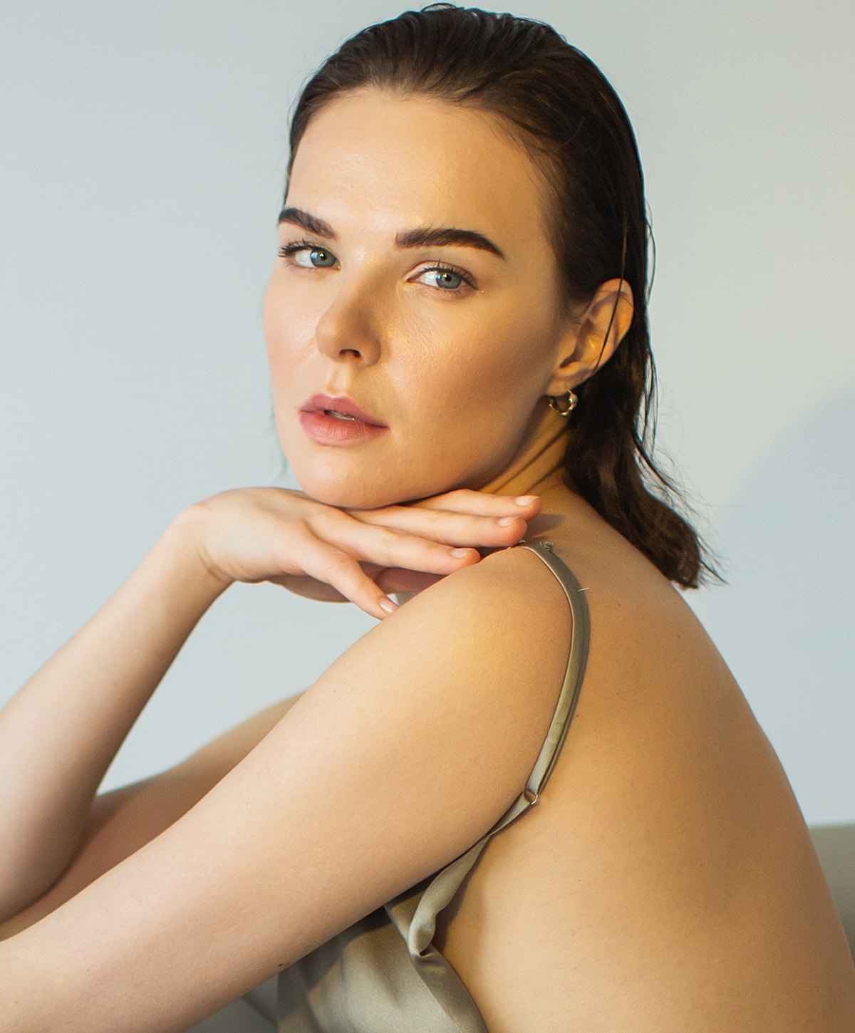 Woman posing gracefully with soft, natural lighting.