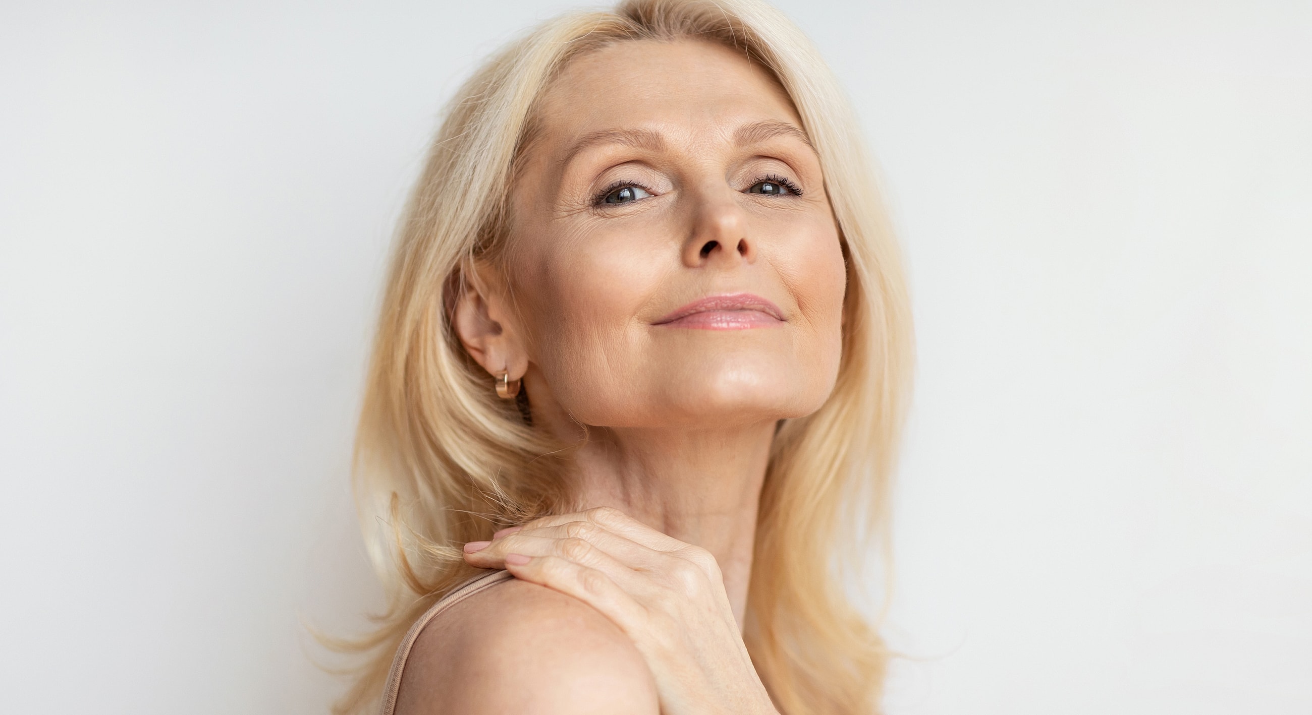 Smiling woman with blonde hair and soft expression.