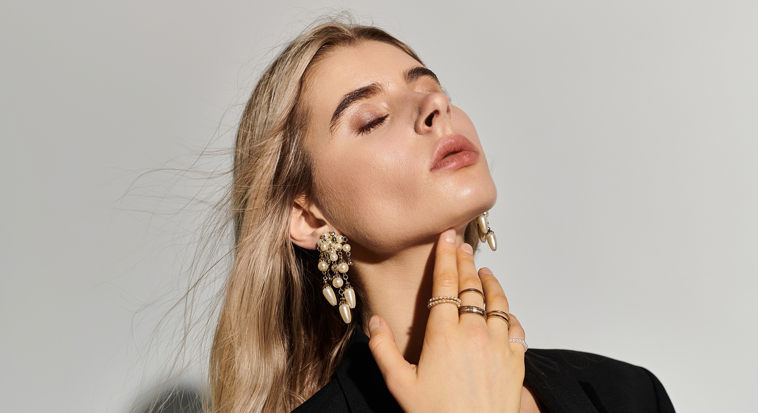 Model showcasing elegant jewelry and hairstyle.