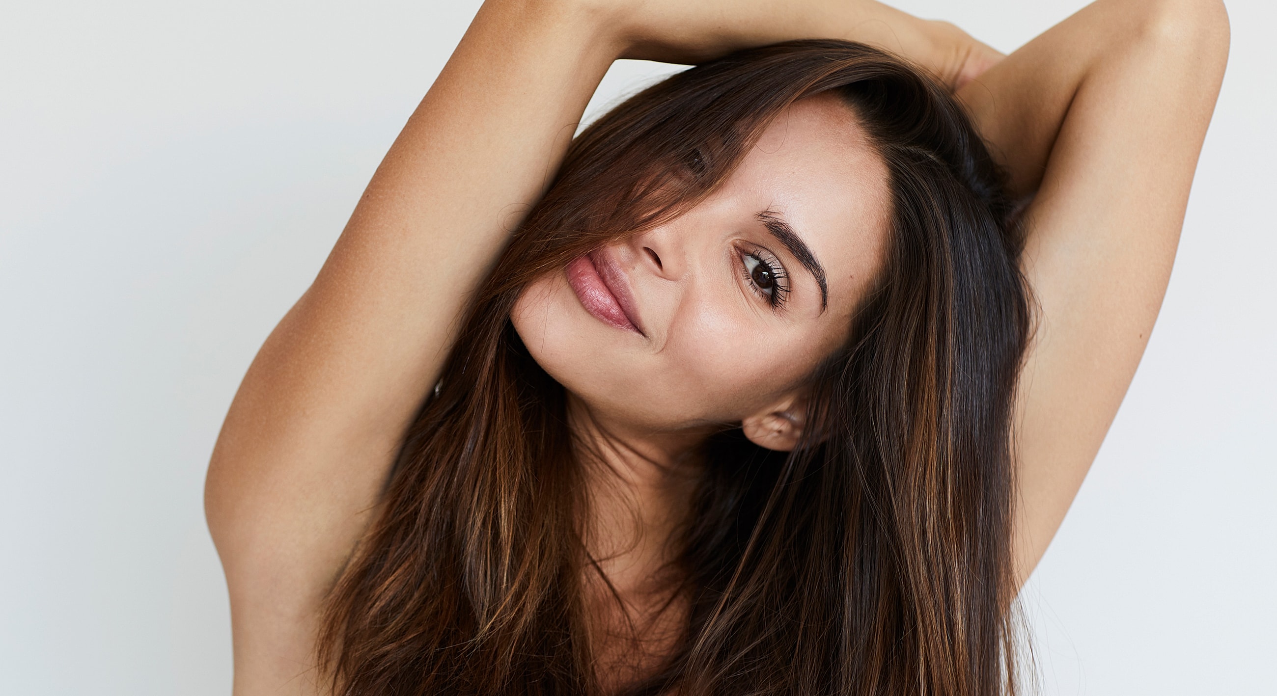 Smiling woman with long, flowing hair.
